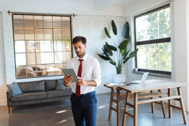 istock Handsome man using digital tablet and app for electronic banking, finances, smart home devices 1465522931