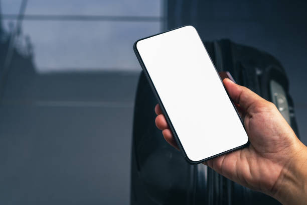istock Hand holding of a smartphone with suitcase background 1465523227