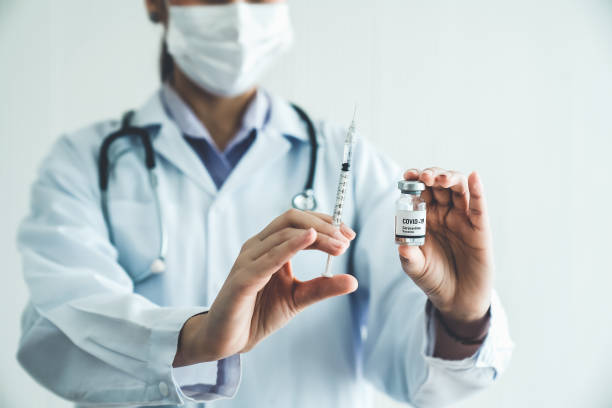 istock Skillful doctor prepare vaccine proficiently before injection . Covid 19 and coronavirus vaccination center service concept . 1465525007