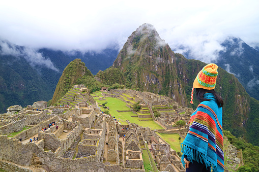 Woman in Poncho and Andean Hat Visiting the Amazing Ancient Inca Citadel of Machu Picchu, UNESCO World Heritage Site in Cusco Region, Peru, South America, ( Self Portrait )