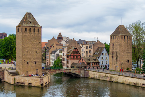 Strasbourg, France – October 16, 2021: Traditional wooden patterned houses on a canal in the downtown of Strasbourg.
