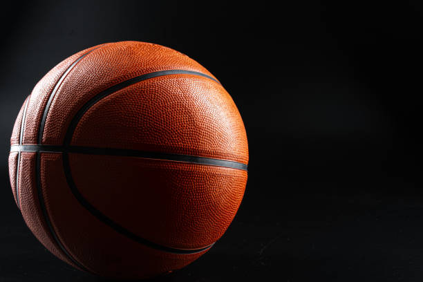 istock Basketball ball close up on dark black background 1465532708
