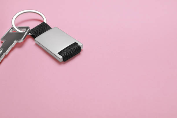 Car key and dutch vehicle registration certificate placed on a white table, representing car ownership, driving license, and road travel