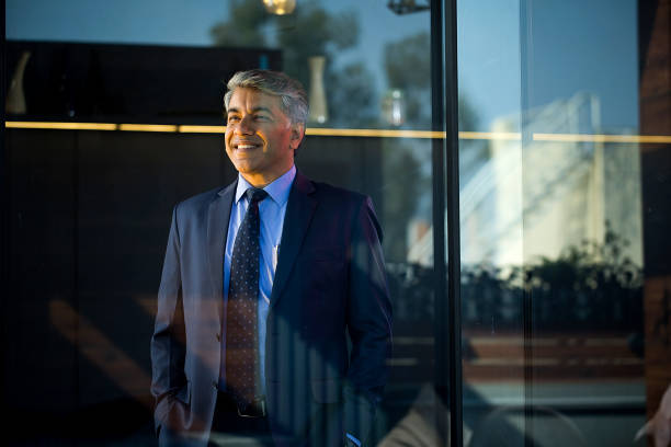 istock Cheerful businessman looking away through glass window 1465534186