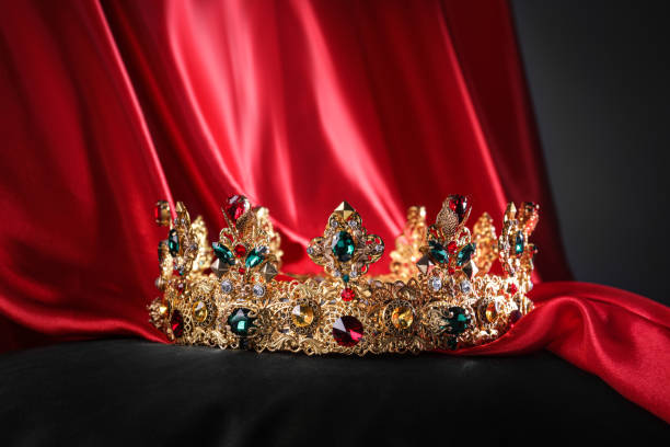 istock Beautiful golden crown with gems on black pillow 1465534218