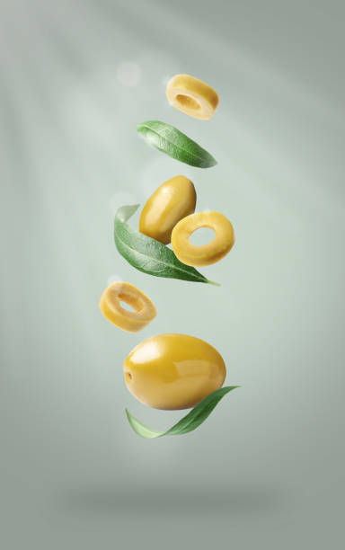 istock Fresh olives and leaves falling on light grey background 1465534527