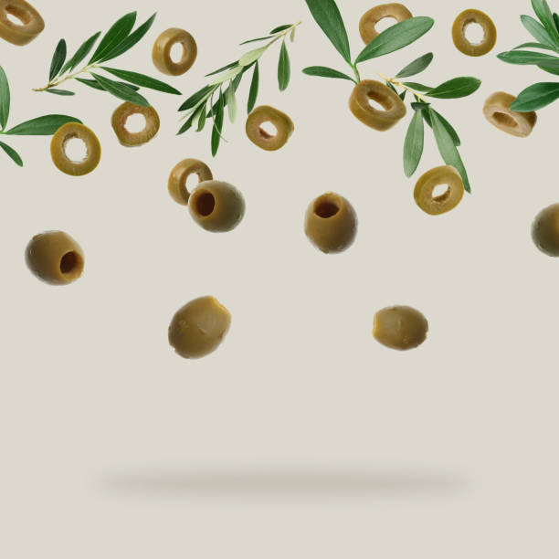 istock Fresh olives and leaves falling on light grey background 1465534537
