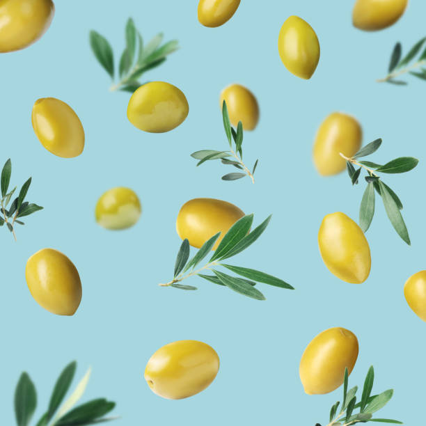 istock Fresh olives and leaves falling on pale light blue background 1465534585