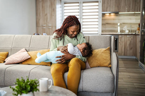 istock Caring black mother looking after her little baby boy while he is asleep 1465539108