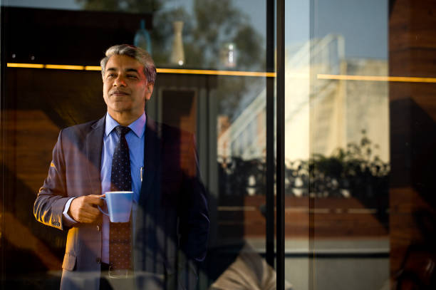 istock Businessman drinking coffee at office 1465539381