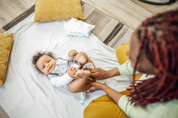 istock Caring black mother changing her baby boys diaper 1465539480