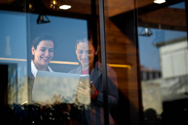 istock Two businesswomen discussing using laptop and digital tablet at office 1465539586