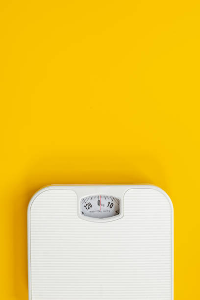 istock Weight control concept. White weight scales from above 1465541034