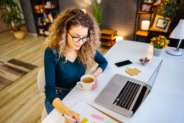 istock Lovely young female student finishing her university project 1465541446