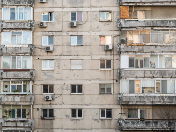 worn out apartment building from the communist era against blue sky in bucharest romania. - 7583 imagens e fotografias de stock