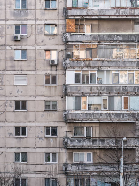 worn out apartment building from the communist era against blue sky in bucharest romania. - 7585 imagens e fotografias de stock