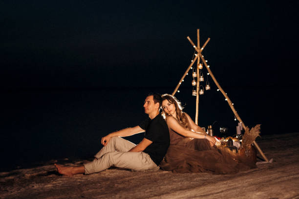 istock young couple having a picnic on the beach 1465541901