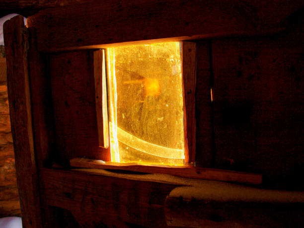 an old door with a broken window, made of weathered wood under the rays of the winter sun. - antique old fashioned close up color image imagens e fotografias de stock