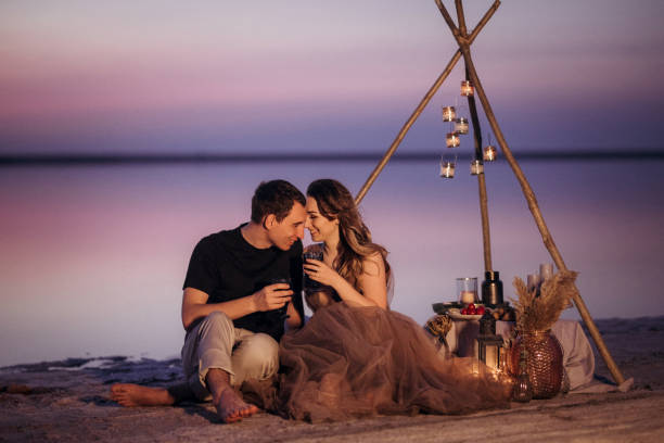 istock young couple having a picnic on the beach 1465542457