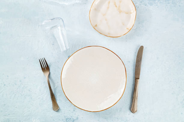 istock An empty plate with cutlery and a wineglass, place setting at a restaurant 1465544596