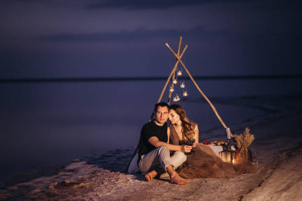 istock young couple having a picnic on the beach 1465545293