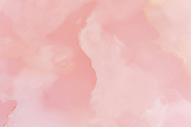 Light pink blurred background made of pink jade or Nephrite