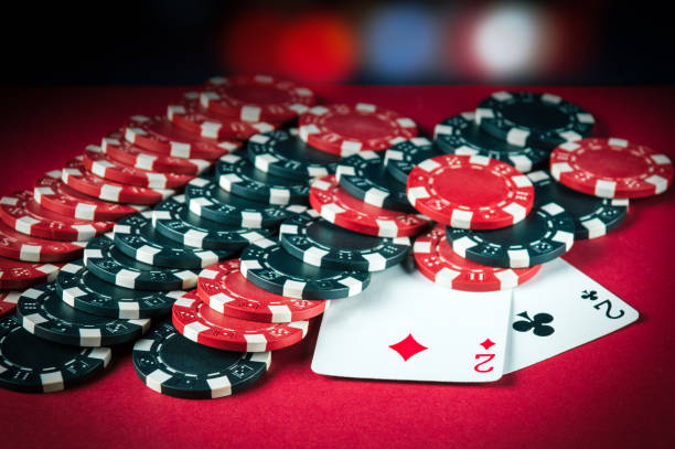 istock Poker game with one pair combination. Chips and cards on the red table. Successful and maximum win 1465546142