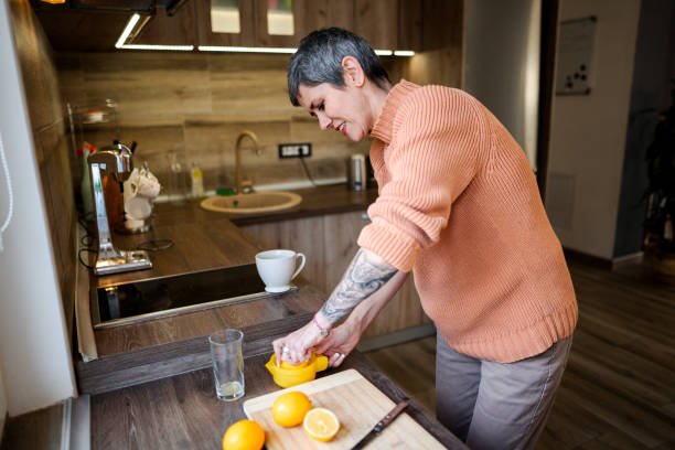 istock Mature woman with arm tattoo making fresh lemonade 1465556161