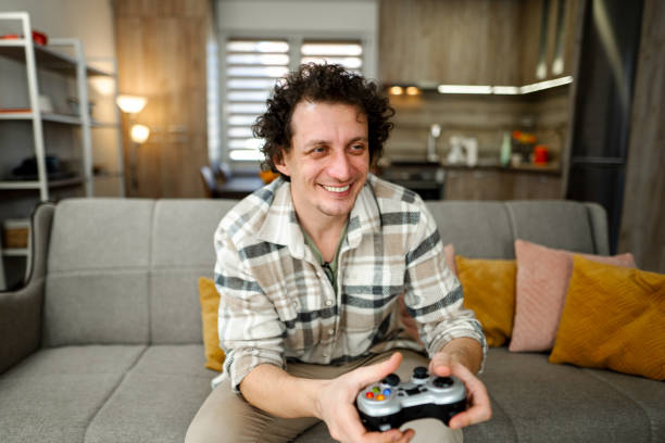 istock Men playing a video game in the living room 1465556349