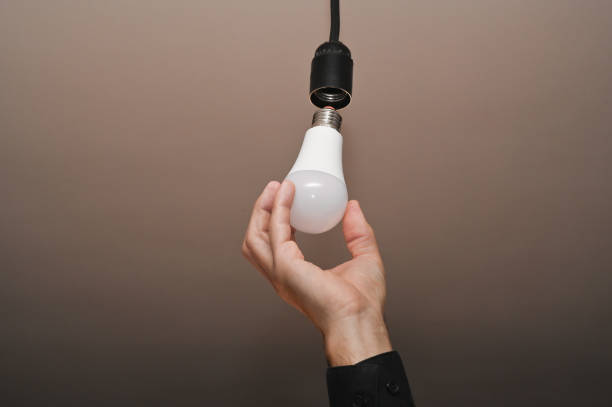 istock screwing in the LED lamp 1465558148