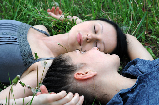 Smiling young woman lying on grass