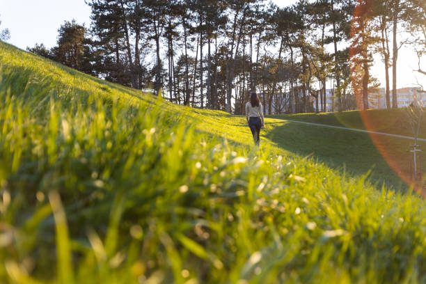 Image of a beautiful young caucasian woman walking in the park.