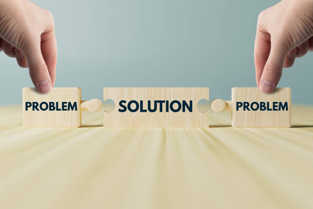 istock The hand holds wooden blocks, a puzzle with the inscription problem and solution. 1465561135