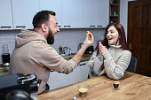 Female Guessing The Capsule Color While Enjoying Coffee With Boyfriend