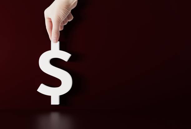istock Hand holds model of dollar sign. 1465562073