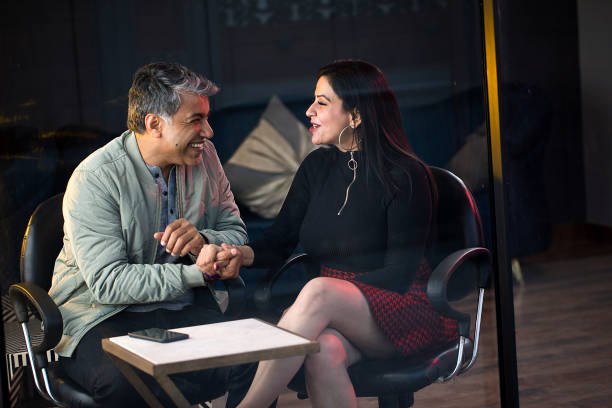 istock Loving couple holding hands and laughing at cafe 1465562292
