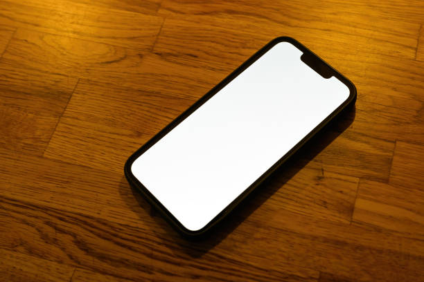 istock Mobile phone blank white screen mockup. Smartphone on hardwood parquet flooring. 1465563889