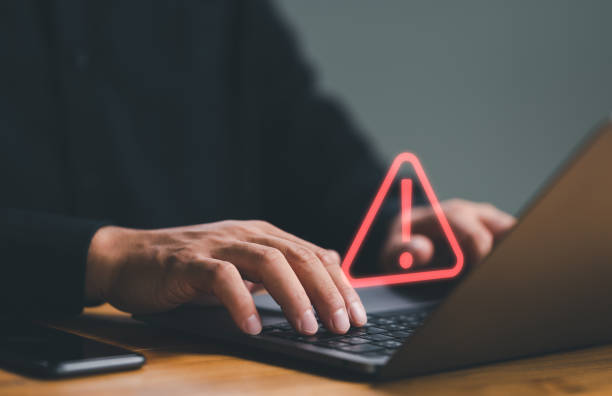businessman or it staff , programmer, developer using computer laptop with triangle caution warning sign for notification error and maintenance concept. - dataintrång bildbanksfoton och bilder