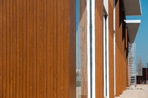 Door made of vertical wooden slats painted in brown