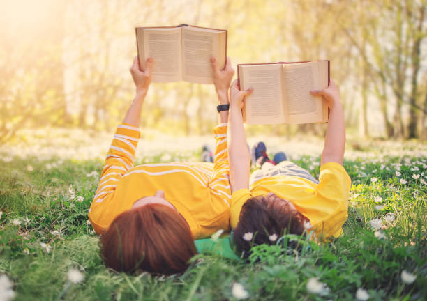 istock Mother and her son lying down on the beautiful spring field in the sunny park. 1465566962