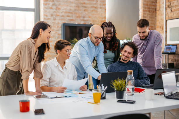 istock Colleagues Watching Something On Laptop While At The Office 1465567127