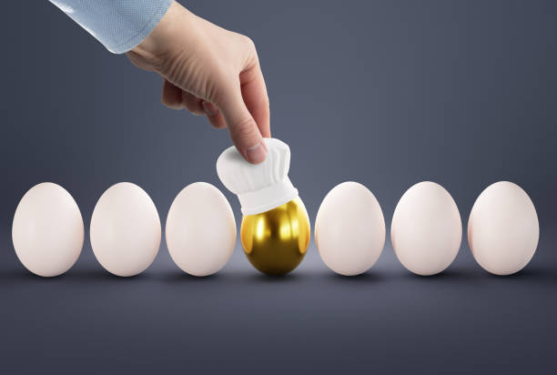 istock The hand puts a cook hat on the egg. 1465567215