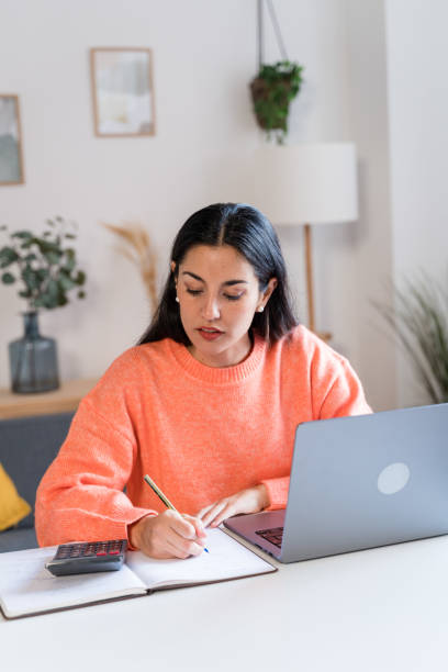 istock Focused woman working on laptop 1465567501