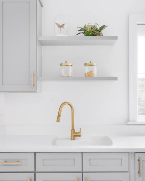 istock A gold faucet detail with grey cabinets. 1465567932