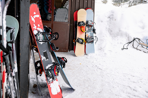 Skies and snowboards in ski resort. Copy space