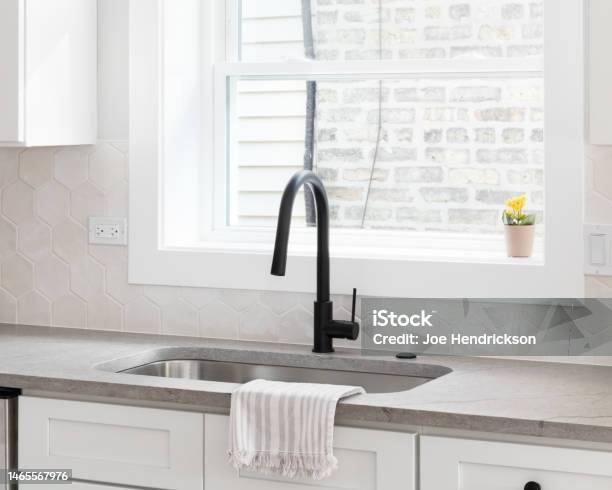 A Cozy Kitchen Sink Detail With A Hexagon Backsplash Stock Photo - Download Image Now