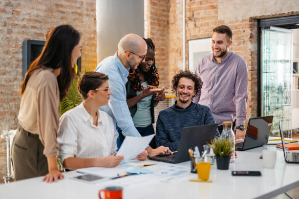 istock Colleagues Watching Something On Laptop While At The Office 1465568140