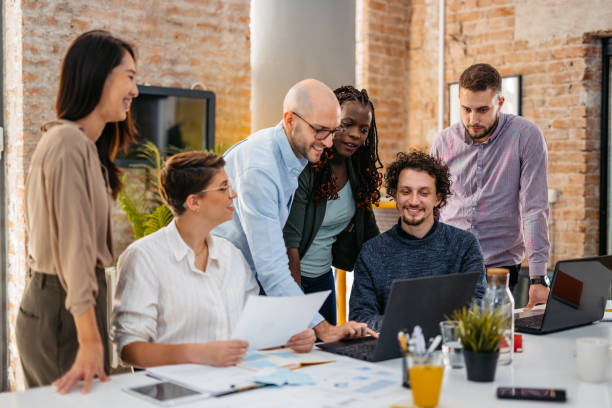 istock Colleagues Watching Something On Laptop While At The Office 1465568351