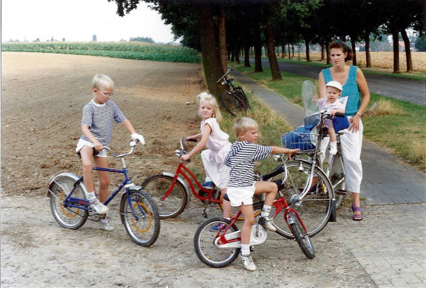 young family on bicycle - group of people 1980s style image created 1980s exercising imagens e fotografias de stock
