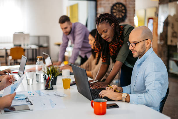 istock Colleagues Consulting With Each Other While Working Together In The Office 1465569465